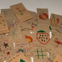 Completed lunch bags decorated by CECI faculty and staff members pile #3